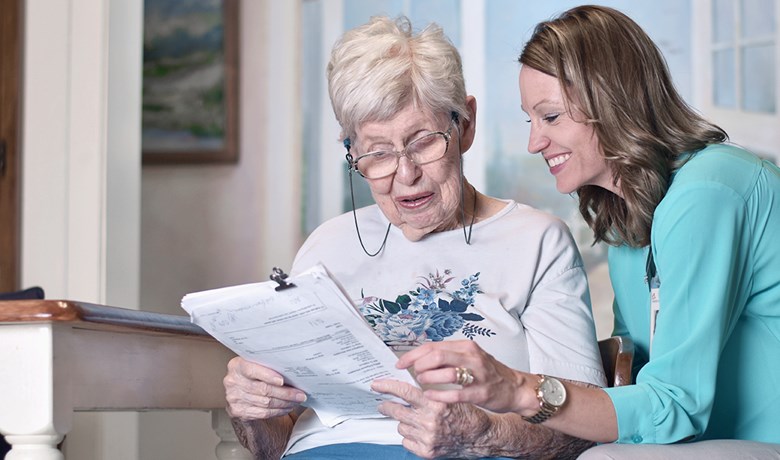 Nurse with patient going through paperwork