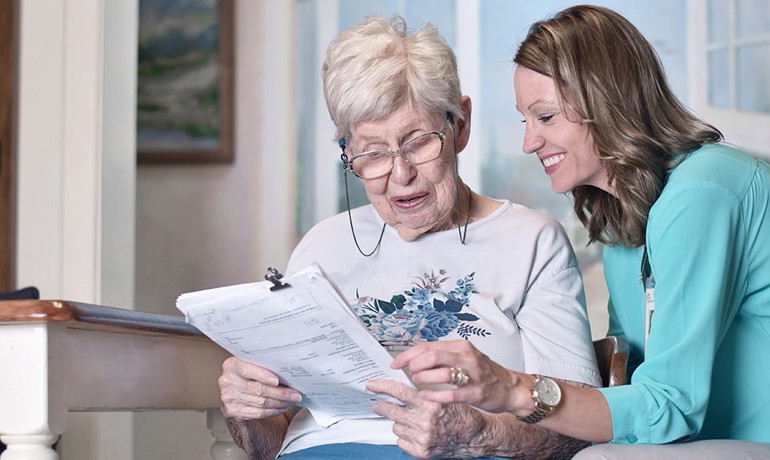 Nurse with patient going through paperwork